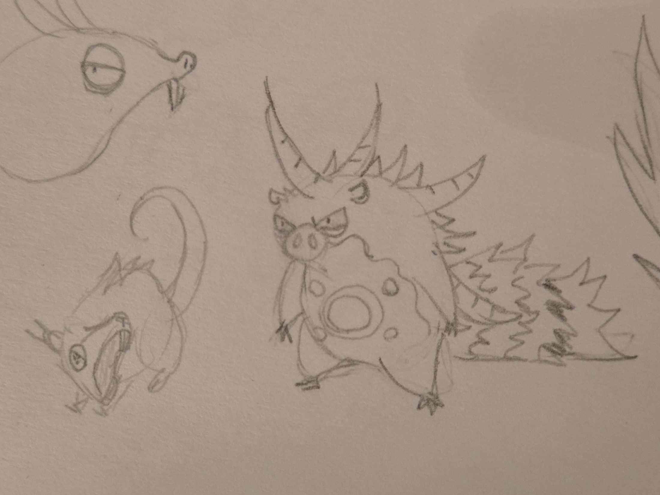 A small furry creature with a long tail and prominent fangs next to a shaggy creature covered in spikes.